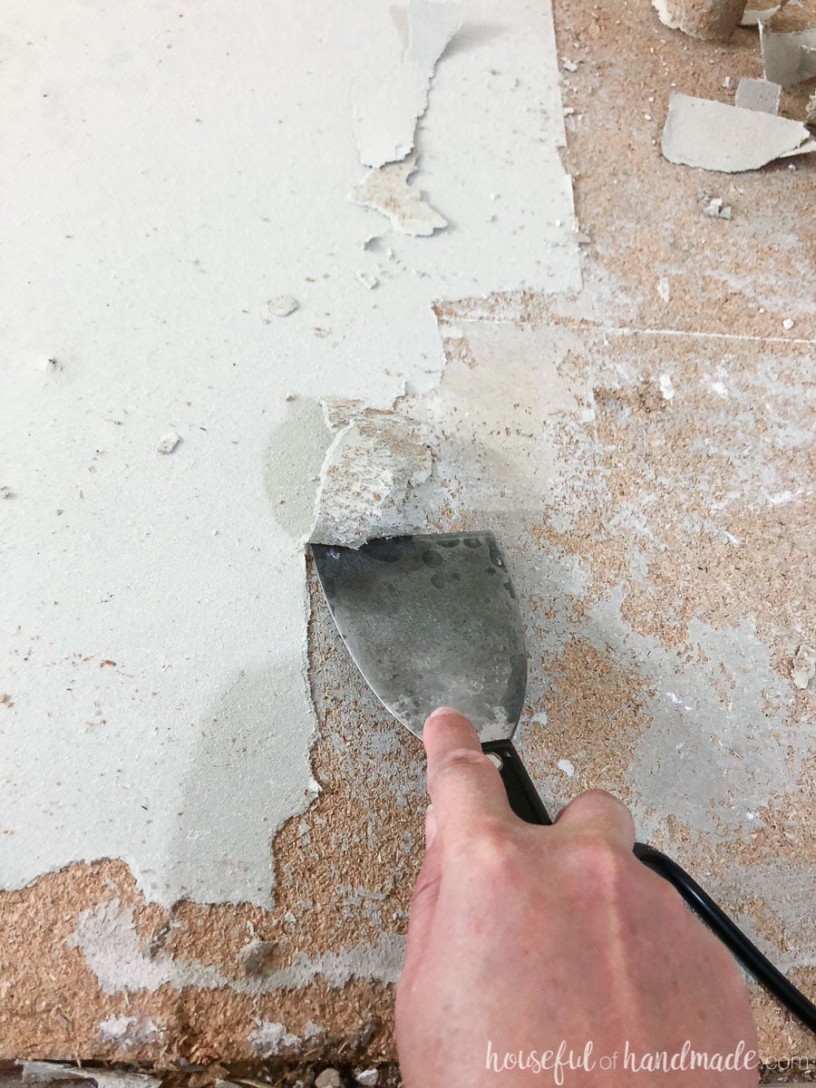 Scrape the layers of old linoleum off the floor with a heat gun and putty knife. 