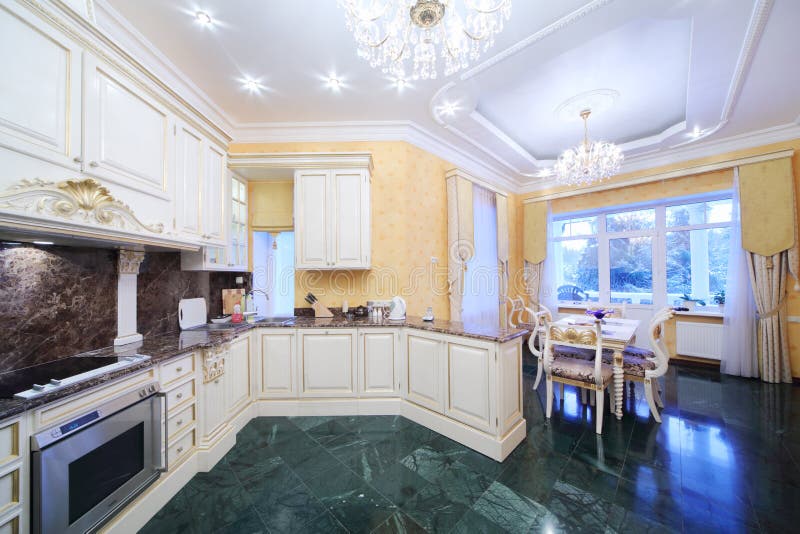 Kitchen with luxury furniture in classic style. Green marble floor stock photography