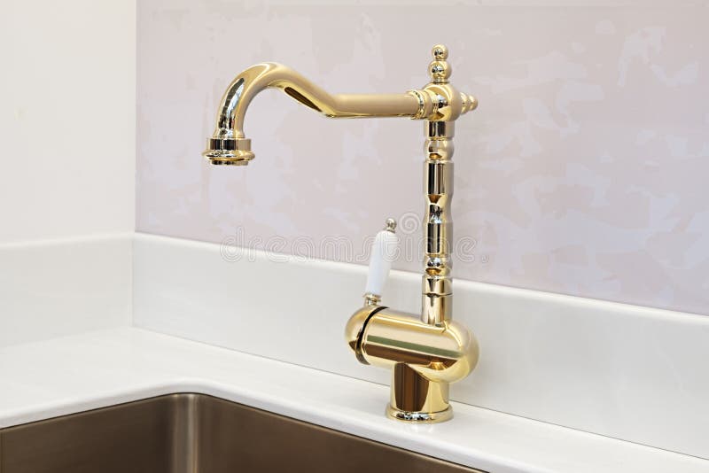 Kitchen luxury retro classic golden faucet. Modern appliances.  royalty free stock photo