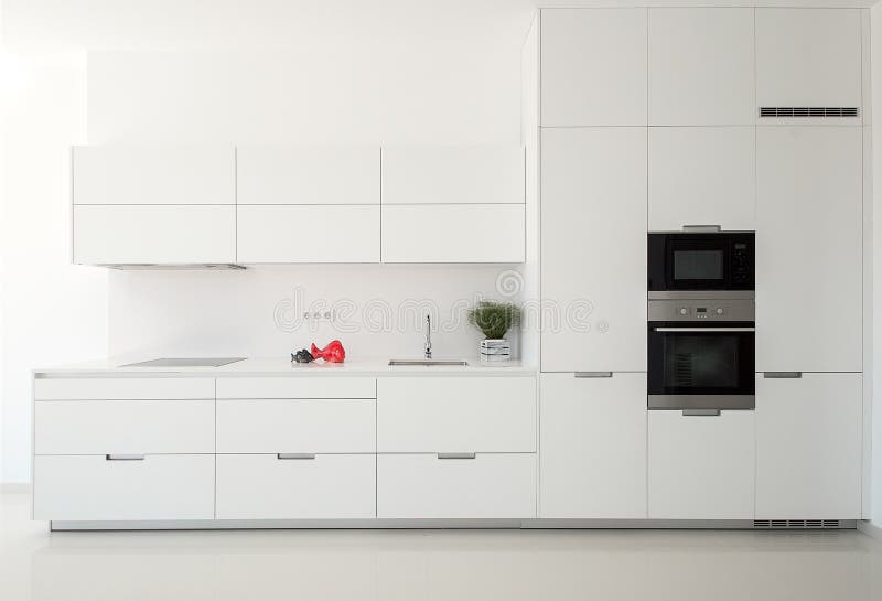 White empty classic kitchen in front view. Kitchen appliances. Modern royalty free stock photography